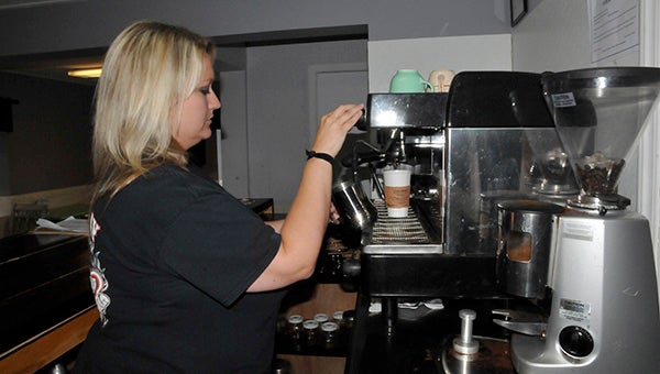 Katrina Mizell, owner of The Coffee Shop, prepares a specialty espresso drink utilizing coconut and mocha flavors.  Photo by Cassandra Favre