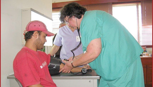 HELPING HANDS: A Christ the Healer volunteer takes the blood pressure of a patient in Nicaragua.  Photo submitted.  