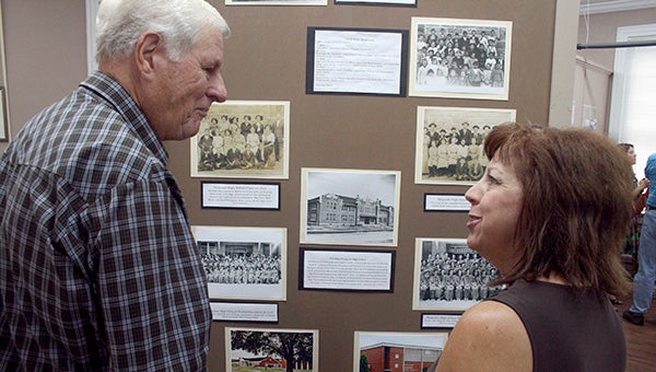 ON DISPLAY: In the photo at top, community members look at a display showing historic images of the Picayune School District from 1909 to 2015.  Photo by Jeremy Pittari
