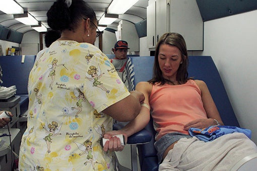 1. DONATING TIME: Emily Loveless was one of the first 20 people who donated blood inside The Blood Center’s mobile bus stationed in front of Acadiana Cinemas on Wednesday. The first 20 donors received free movie tickets. Photo by Ashley Collins.