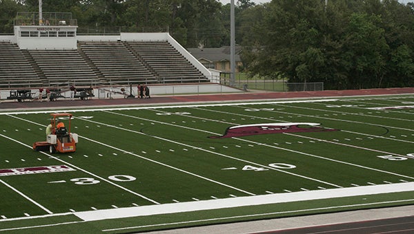 READY FOR FOOTBALL: The newly installed turf at PMHS football field was being prepared for Thursday’s Meet the Tide event. The turf was made possible by donations from the newly formed Maroon Tide Nation Foundation.  Photo by Cassandra Favre 