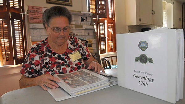 TIME TRAVEL: PRC Genealogy Club member Gloria Penton looks through books reliving the club’s early days.  Photo by Cassandra Favre 