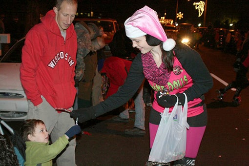 Christmas spirit: Families line the streets of Picayune for candy, a glimpse of Santa and Mrs. Claus in the annual Women’s Club of Picayune Christmas parade. The club is seeking entries now, and the number of entrants is capped at 75. 