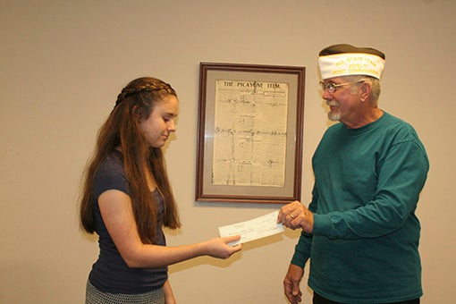 SCHOLARSHIP RECIPIENT: Pictured, Ronald Lowe hands Madeline Hays the scholarship. Photo by Ashley Collins.