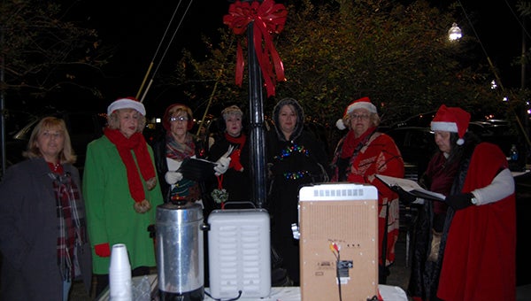 Christmas carols: The Senior Center carolers performed during Friday night’s event.  Photo by Cassandra Favre