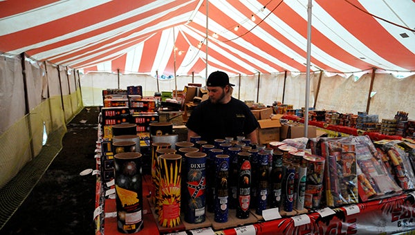 Jesse Wright | Picayune Item just add fire: Ryan Johnson, a worker at an area Crazy Carl’s Fireworks stand, shows off some Crackling Artillery Shells, one of the more popular types of firecracker. Other favorites include the Crazy Crawfish and the bottle rocket. 