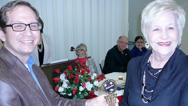 From left, senior center board president Eddie Smith presents Edna Creel with a trophy designating her as the 2015 Volunteer of the Year.  Photo submitted