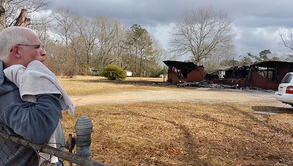 SAFE AND SOUND: Mark Best stands outside his home, which burned during a Monday morning fire.  Photo by Jeremy Pittari