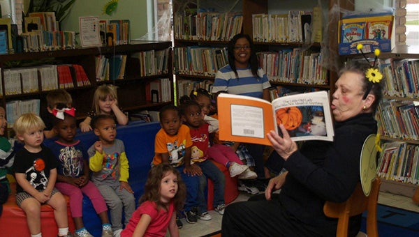 Sylvia Bernard, in a bee costume, reads to the children at story hour. Photo submitted 