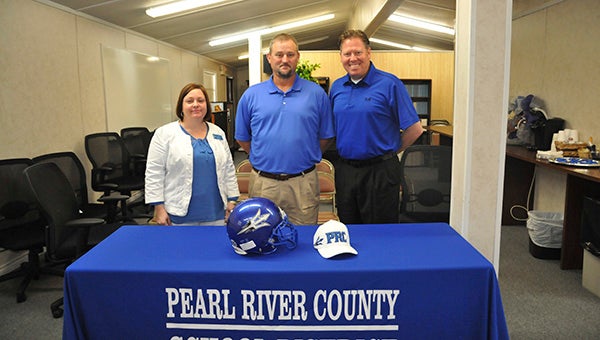 NEW COACH: Friday, the PRC School Board hired Larry Dolan as the Blue Devils new head coach. Pictured from left are PRC High School Principal Stacy Baudoin, Dolan and PRC Superintendent Alan Lumpkin.  Photo by Cassandra Favre