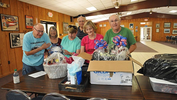 PREPARATION: Members of the SMART South Central region organize gift baskets for this week’s door prizes.  Photo by Cassandra Favre 
