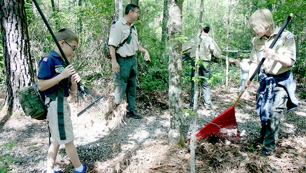 SPRUCING UP: A group of scouts from Troop 2 spent their Saturday cleaning up this trail at the Crosby Arboretum as part of the local attraction’s new Adopt A Trail program.  Photo by Jeremy Pittari