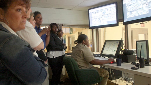 NERVE CENTER: Participants of the Pearl River County Partners in Leadership class toured the Pearl River COunty jail on Thursday, during which they got a chance to see this office, which serves as the nerve center of the entire jail.  From this office jail staff can see every aspect of the jail and where emergency attention may be needed.  Photo by Jeremy Pittari