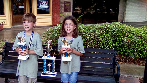 COMPETITIVE : Saturday, Picayune twins Cooper and Chloe Farmer placed sixth and seventh in the stock car division at the Deborah Washington Soapbox Derby in Moss Point.  Submitted Photo