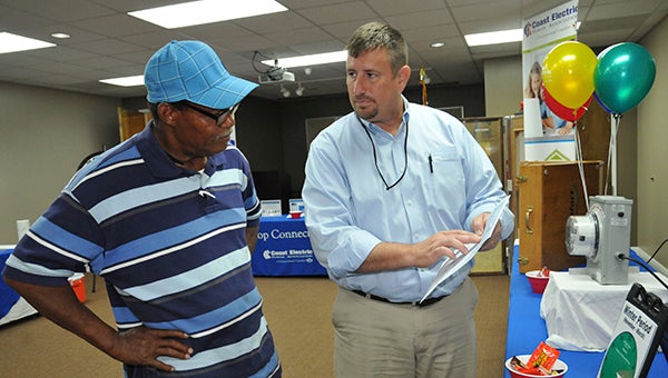 SAVING ON ENERGY: From left, Coast Electric member Robert Landor speaks to Senior Residential Energy Management Representative for the Pearl River County District Scott White about Coast Electric’s Time-of-Use rate plan.  Photo by Cassandra Favre  