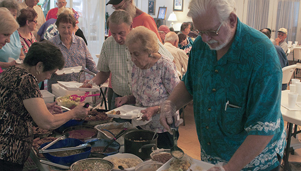 Senior citizens line up to eat a nutritious meal consisting of a wide variety of food at the Senior Center in Picayune. This is part of their Pot Luck Lunch they hold at the center every other Friday.
