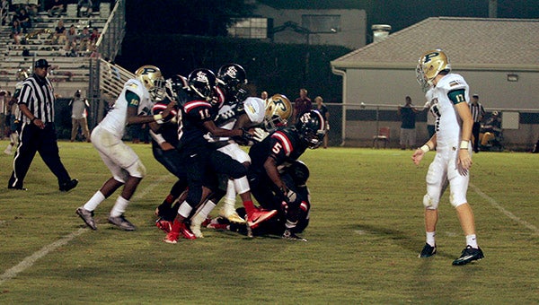 Poplarville running back Jesse Pernell carries a pile of defenders with him as he inches toward the end zone.