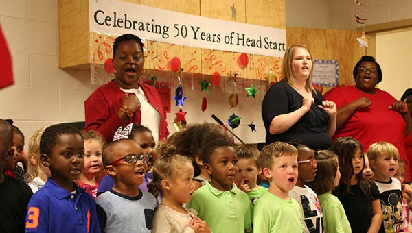 Students of the Head Start program in Poplarville sing “The Wheels on the Bus Go Round” in celebration of the program’s 50th anniversary. 