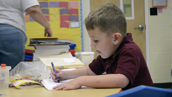 Julie Dennis teachers her kindergarten class at Westside about the difference between natural and man made objects, asking them to draw their favorite natural environment. Photo by Julia Arenstam