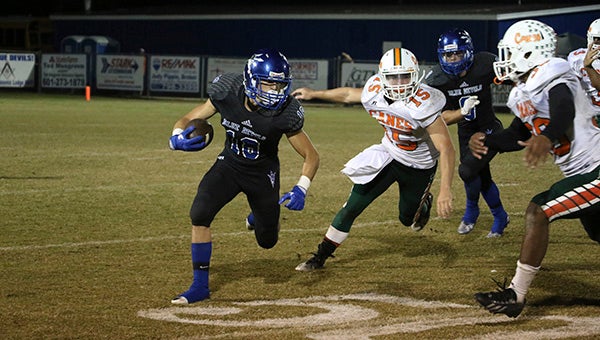 Sophomore Blue Devil Ryan Spradley runs up the pitch for a gain of eight yards in the late minutes of recent district action.