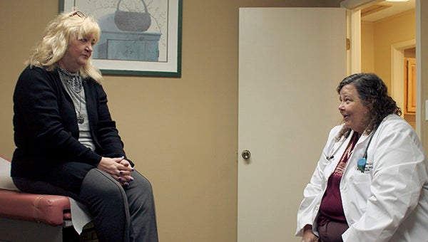 BUILDING FAMILY BONDS: Kim Mitchell-Silver speaks with a patient at her new practice in Picayune. Photo by Taylor Welsh