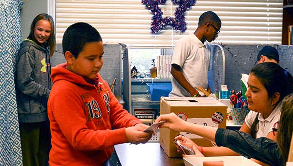 After turning in their ballots, Nicholson Elementary students received pencils and measuring cards about the importance of voting. Photo by Julia Arenstam 