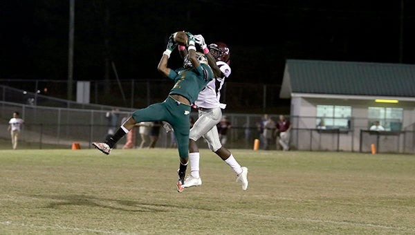 Hornets' wide receiver Ariteaus Johson picks off an interception Friday against the Aggies. Photo by Jeremy Pittari