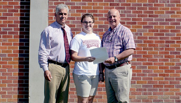 Picayune Memorial High School gruaduate, Danielle LeClercq (center), was one one of eight students in the state to receive a $1,000 scholarship from the Mississippi Association of School Superintendents. Picayune School District Superintendent Dean Shaw (left) and Picayune Memorial High School Principal Kent Kirkland (right) presented her with the scholarship on Friday. Photo by Julia Arenstam. 