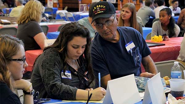 A Picayune Memorial High School students speaks with a local veteran about his experience in the service at their annual Veteran's Day event. Photo by Julia Arenstam 