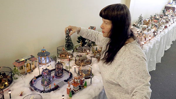 FINISHING TOUCHES: Marie Whitman had only a week to assemble her ever-growing collection of holiday themed collectibles to create the annual  WhitmanVille Village.  Photo by Jeremy Pittari