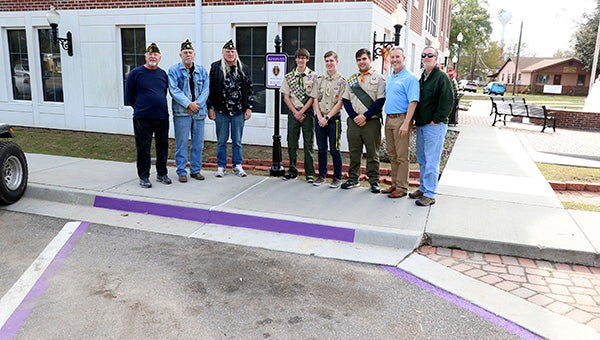 SPECIAL PARKING: An Eagle Scout project by Neil Frierson, pictured center right, established three parking spaces in the city of Picayune for Purple Heart recipients.  Photo by Jeremy Pittari