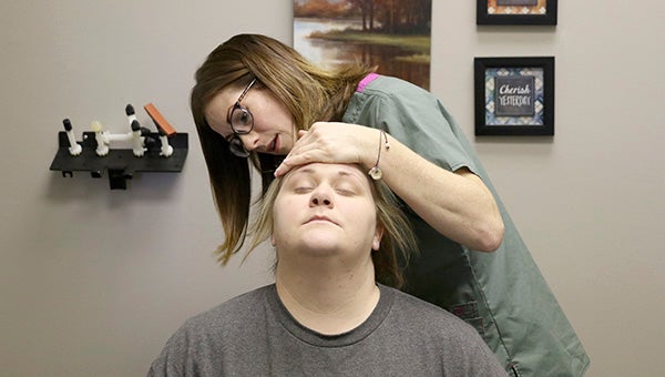 READJUSTMENT: Dr. Misty Jenkins performs chiropractic care on her patient, Cassie Aycock, at Cornerstone Chiropractic in Poplarville.  Photo by Jeremy Pittari