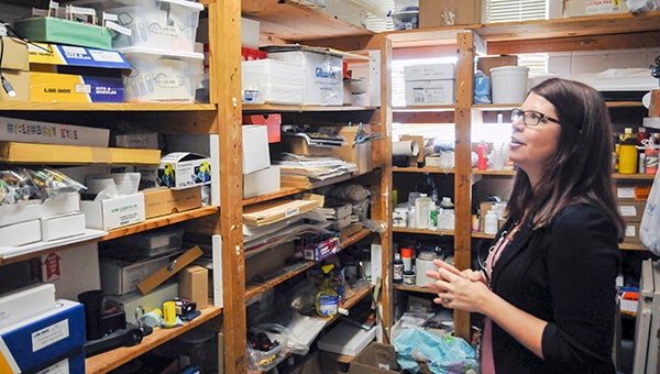 In a closet filled with outdated science lab equipment, Karen Boutwell stresses the importance continually updating the technology students use to benefit them once they enter the real world. Photo by Taylor Welsh