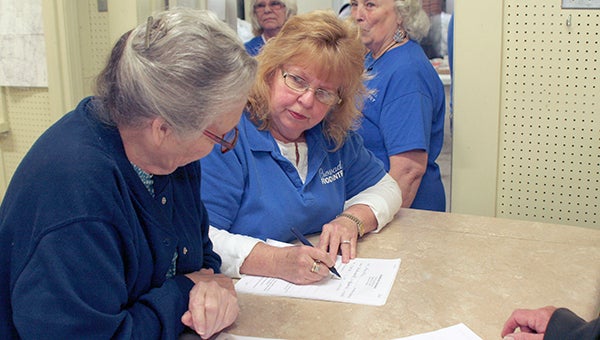 Kerry Scalise helps clients renew their paperwork to keep the Crossroads Food Pantry records up-to-date.