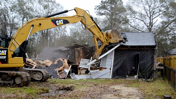 The Picayune Public Works Department removed a blighted home on South Jackson Avenue Thursday morning. The City Council declared the property a menace in October after a fire earlier last year destroyed the building. Photo by Julia Arenstam 