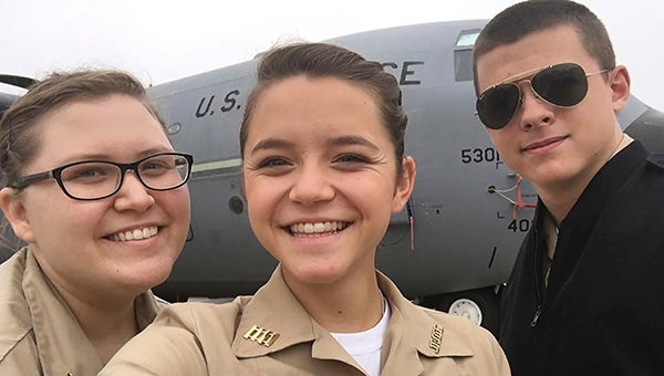 Pictured from left to right, Ally Beasley, Cheynne Ingersoll and Bradley Counts get ready to embark on the C-130 aircraft. 