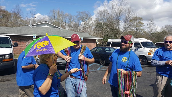 After lunch, the Mardi Gras party moved outdoors during a beautiful Tuesday afternoon where Rotarians prepared for the second line parade. Photo by Linda Gilmore