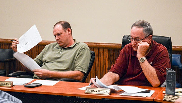 Poplarville Aldermen Glenn Bolin and Byron Wells, both running for mayor this year, review proposals for a new public works building. Photo by Julia Arenstam 