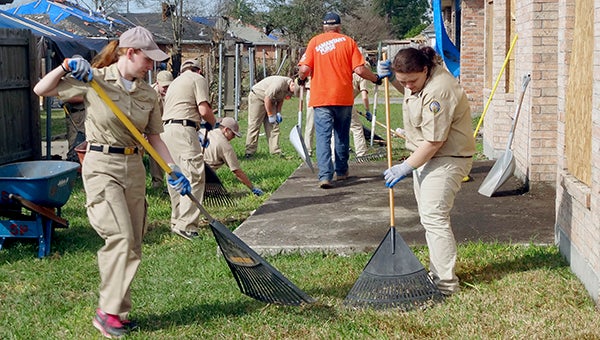 PRC NJROTC cadets finish clearing debris at a tornado victim's household in East New Orleans.