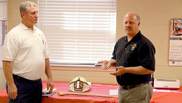Fire Chief Keith Brown, gives Battalion Chief Dennis Beech his badge, helmet a fire ax and a plaque for his years of service to the city of Picayune as a firefighter.  Photo by Jeremy Pittari